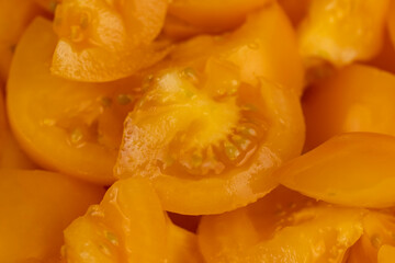 ripe orange tomatoes cut into pieces of different sizes