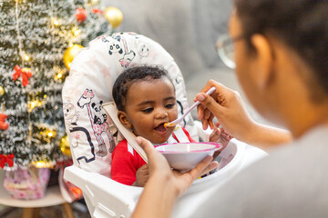 Spontaneous reaction of a child when introduced to food, eating for the first time. Rio de Janeiro, Brazil.