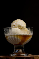 creamy balls of fresh white ice cream with the taste of maple syrup in a glass