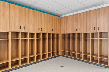 A large room with wooden cabinets and a metal trash can