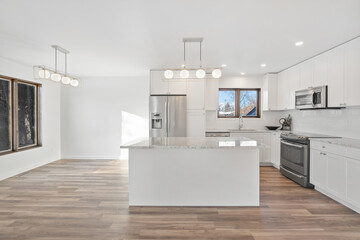 A kitchen with a white counter and a black stove
