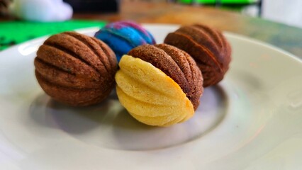 A plate of four different shaped cookies