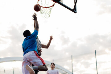 Basketball player shooting ball during game with teammates