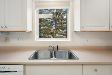 A kitchen with a sink and a window