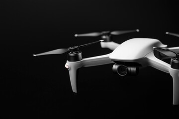 close-up of a white quadcopter on a dark background