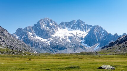 Majestic snow-capped mountains, alpine meadow, clear sky, summer landscape, travel postcard