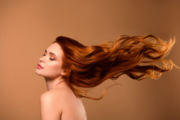Photo of pretty gorgeous girl fluttering hair spa salon procedure shoulders off isolated on beige color background