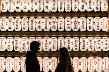 Kyoto, Japan - Dec 27 2024: Couples enjoy a peaceful evening admiring illuminated lanterns at a temple