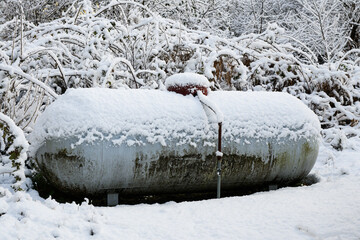Snow covered residential propane tank in winter