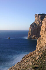 the Cala Viola gulf in the Porto Conte Regional Park, Alghero, Sassari, Sardinia, Italy. Long exposure and Motion blur on sea waves.