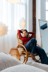 a woman in the Christmas decorated rom with a spruce tree ms Santa