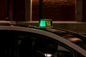Yellow Taxi Sign on Top of a Vehicle