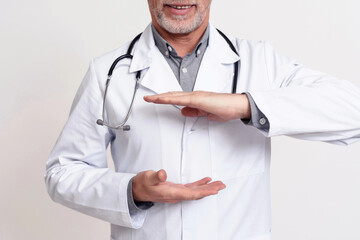 Portrait of doctor with stethoscope holding hands isolated.