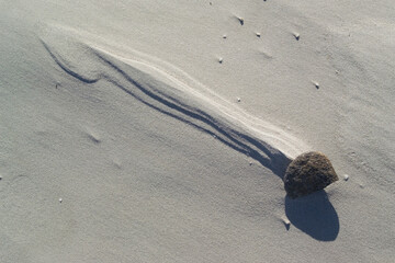 wind marks on the beach Shapes sculpted by the wind and surf around pebbles  on La Cinta beach. San Teodoro Nuoro, Sardinia. Italy