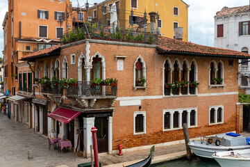 Corner of old residential house with windows and balconies in Venice