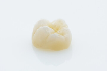 High-quality zirconia dental crown on white background. Dental ceramic crown professional dental lab