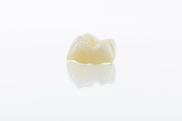 High-quality zirconia dental crown on white background. Dental ceramic crown professional dental lab