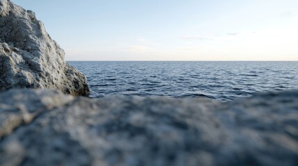 Calm ocean view from rocky shore at sunset, peaceful seascape for travel brochure
