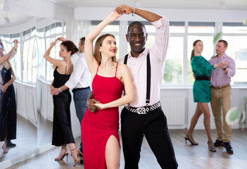 Naklejka premium Classical dances performed by women and men in beautiful festive clothes