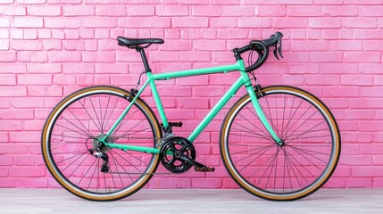 Fototapeta premium Mint green road bike against pink brick wall