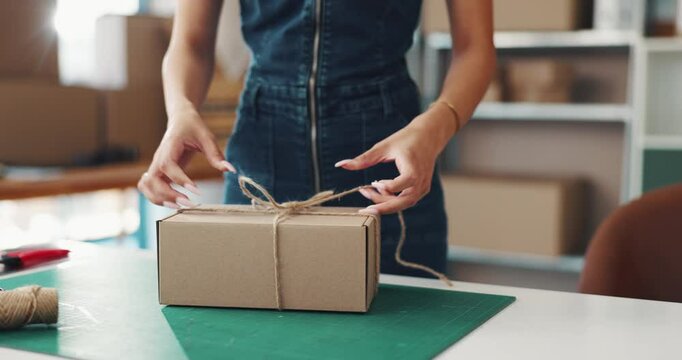 Woman, tie and hands with box for delivery, supply chain or packaging order at warehouse. Small business, strings or owner wrapping parcel, cargo or product for shipping or courier service at shop
