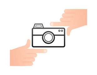 Fototapeta premium Two hands framing a camera icon, taking a photo concept