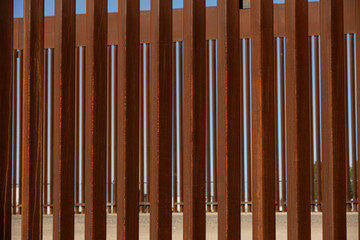 Obraz premium Afternoon view of the iron metal border wall between San Luis Río Colorado, Sonora, Mexico and San Luis, Arizona, USA