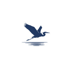 Silhouetted Heron in Flight Over a Calm Lake Surface Reflection
