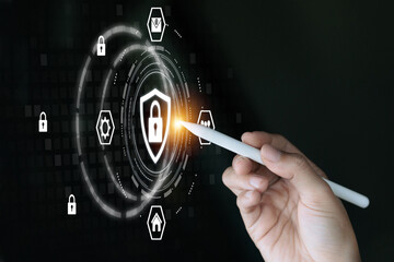 A person is pointing at a screen with a white pen. The screen has a security symbol with a lock on it