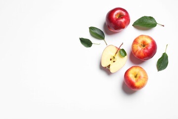 Flat lay composition with whole and cut apples on white background. Space for text