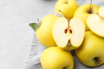Fresh ripe yellow apples on grey table, closeup. Space for text
