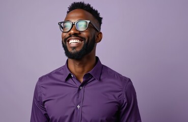 Happy African American man wearing eyeglasses, purple shirt. Studio shot. Positive expression. Confident pose. Stylish man. Great for business fashion. Excellent choice for portfolio. Modern look.