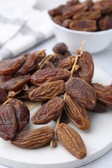 Tasty dried dates on light table, closeup