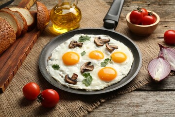 Tasty fried eggs with mushrooms and parsley served on wooden table