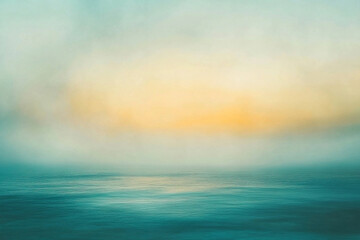Obraz premium Serene sunrise over a calm ocean, with soft blue and gold hues blending in the horizon
