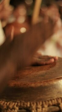 close up of people playing atabaque and berimbau in a capoeira circle. Afro percussion instrument