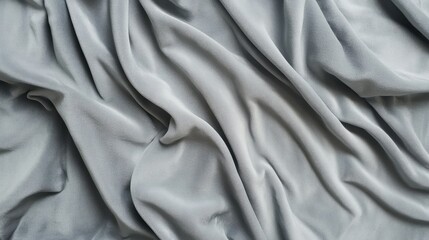 Obraz premium Close-up of textured, gray fabric with soft, flowing drapes and folds creating an elegant, abstract background.