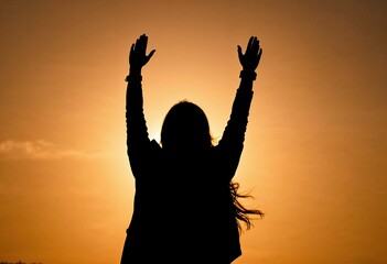 silhouette of woman with raised hands