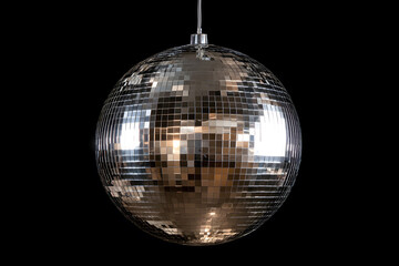 Silver disco ball shining brightly against a black background, reflecting light beautifully