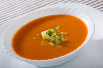 Andalusian traditional cold soup gazpacho in bowl with cucumber