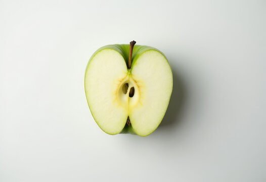 Halved Green Apple with Stem and Seeds on White