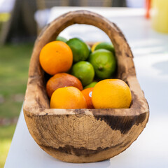 Oranges and Limes In Hand Hewn Wooden Basket