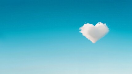 A fluffy heart-shaped cloud floats against a clear blue sky, evoking feelings of love and tranquility.