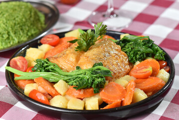 codfish typical Portuguese dish baked cod with onion garlic peppers and potatoes rustic Portuguese food salted fish cooked olive oil