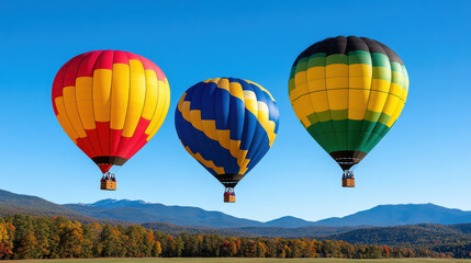 Naklejka premium Colorful hot air balloons soaring in clear blue sky over mountains