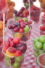 Colorful fruit cups displayed at a local market during the day