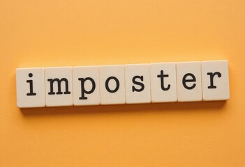 Wooden tiles spelling 'imposter' on a light orange background, feelings of self-doubt and inadequacy in personal or professional settings. Imposter syndrome concept
