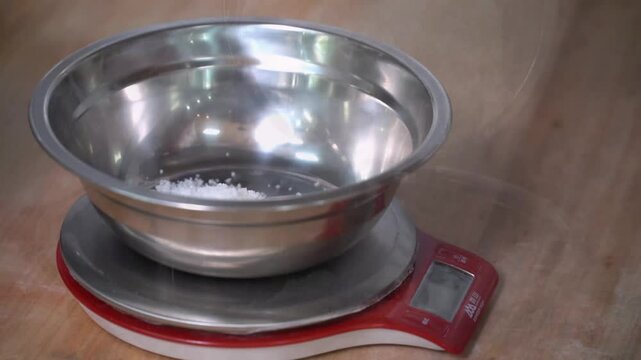 Precision in pastry preparation at an Ultra HD production facility, showcasing the meticulous weighing of ingredients