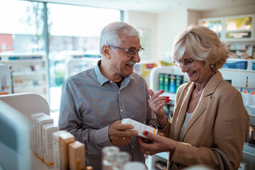 Elderly couple shopping for medication at pharmacy