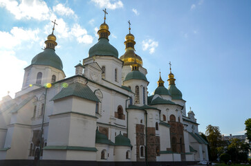 St Sophia Cathedral with golden domes, featuring stunning architecture and illuminated under sunlight, conveying spirituality and cultural heritage in a serene setting. Kyiv, Ukraine